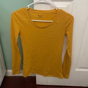 A mustard yellow long-sleeve top.